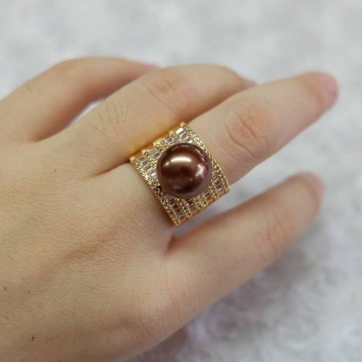 Pearl grading expert examining golden South Sea pearls