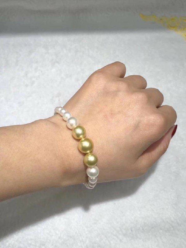 South Sea pearl strand displayed on dark fabric showing luster